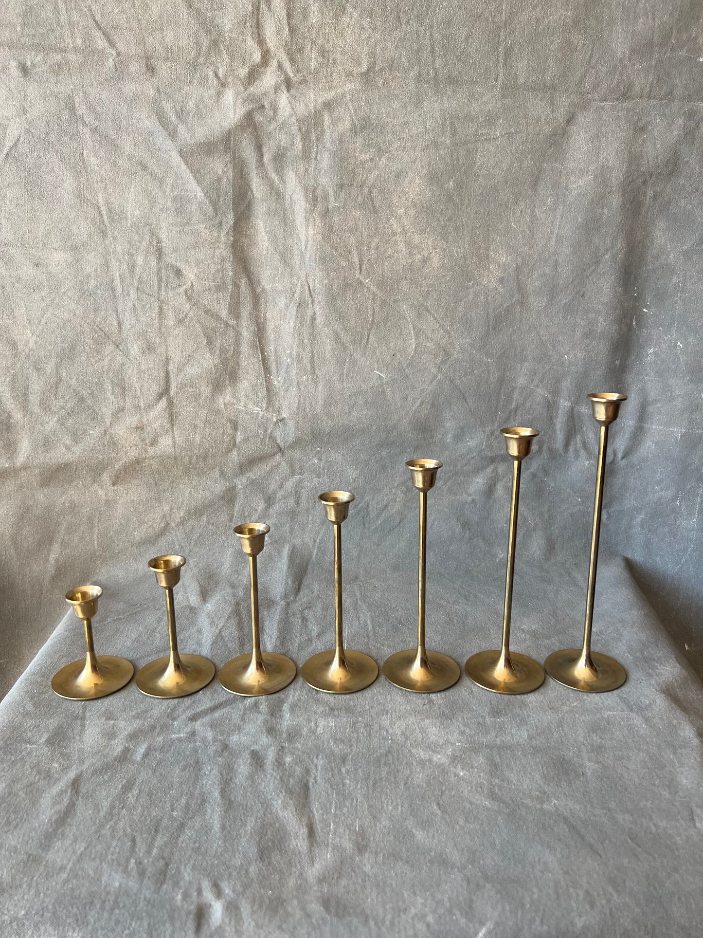 Set of Seven Slender Mid Century Brass Graduated Candle Holders