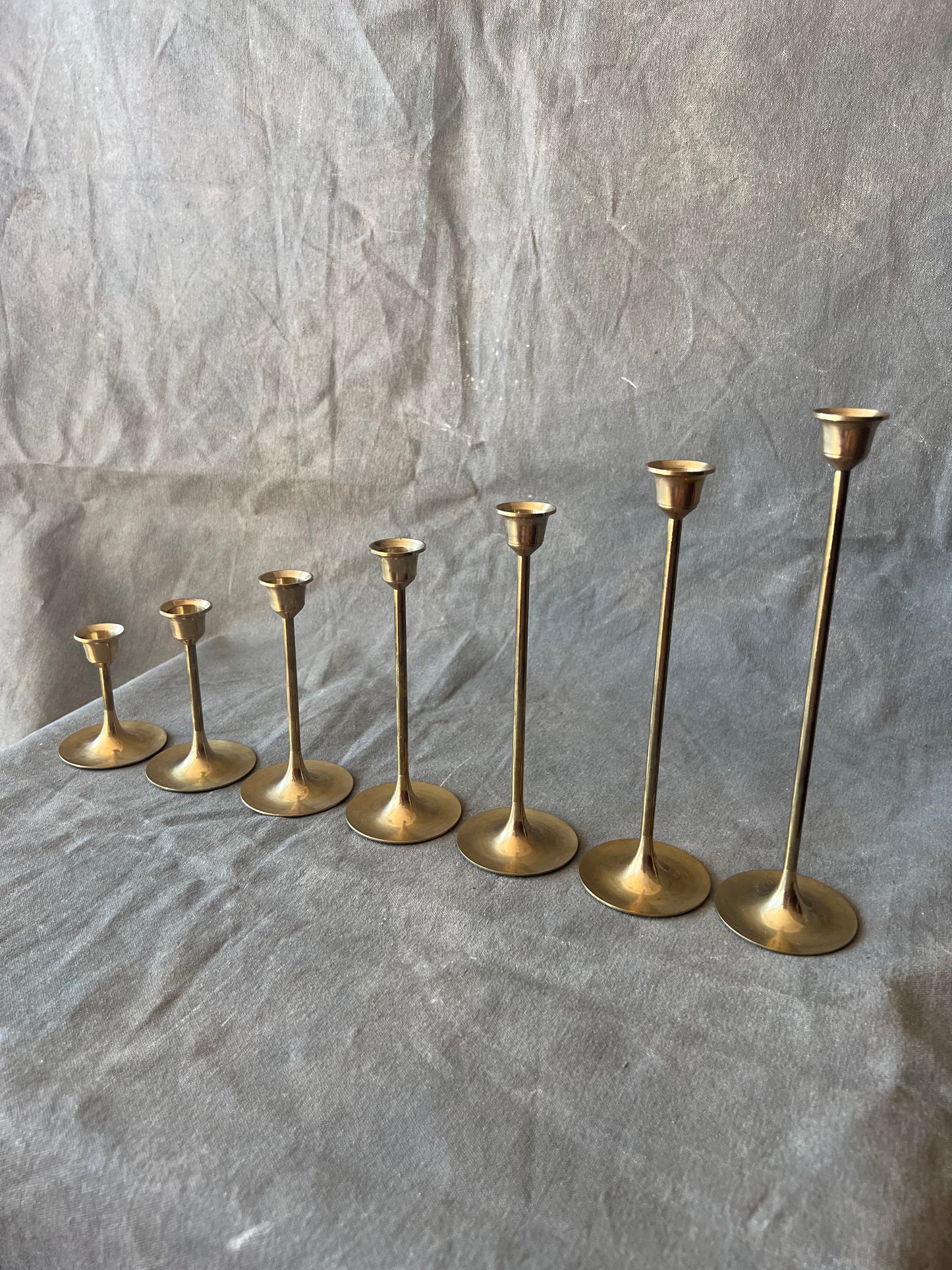 Set of Seven Slender Mid Century Brass Graduated Candle Holders